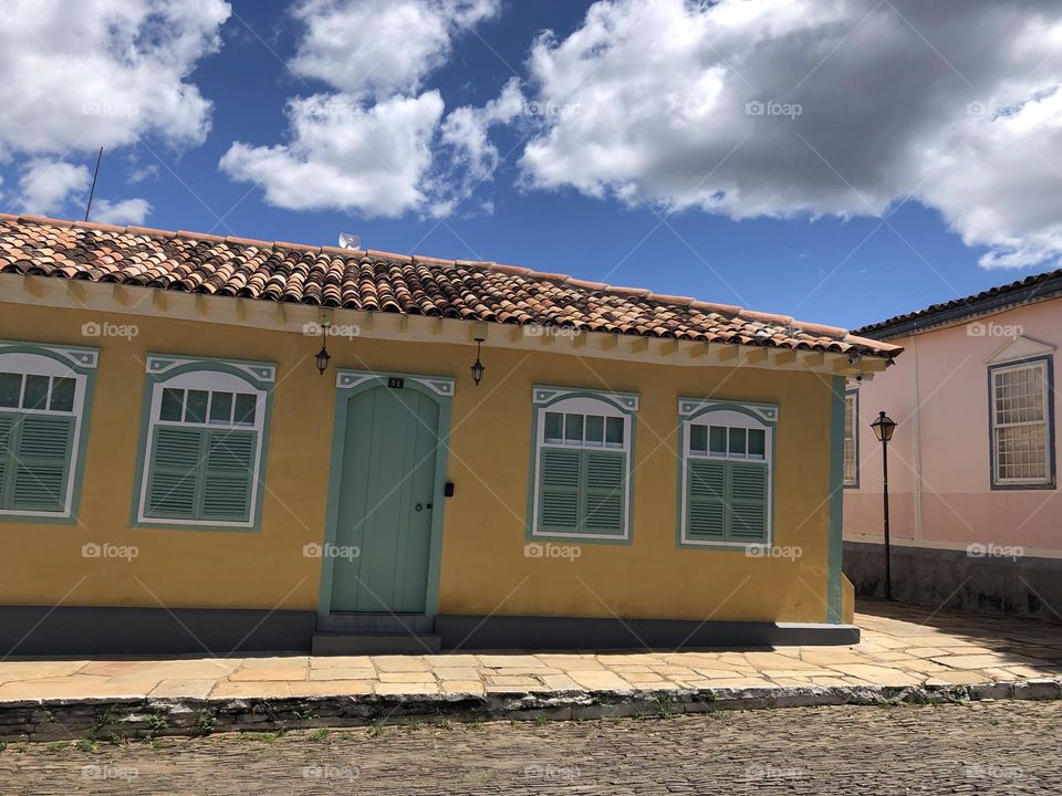 Colorful historical house in green and yellow over the sunlight 