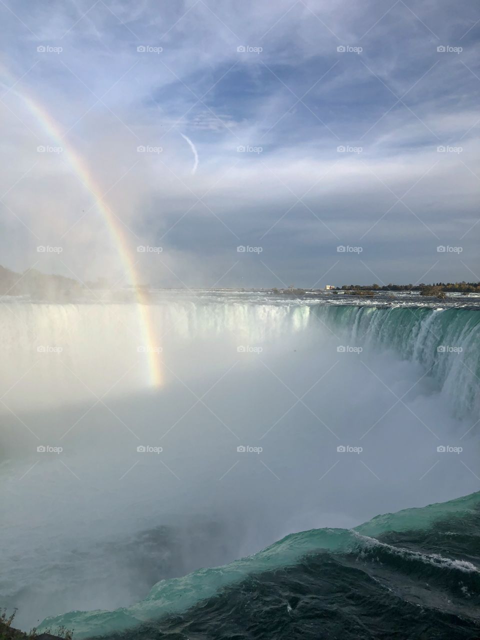 Beautiful rainbow in Niagara Falls on a sunny day 