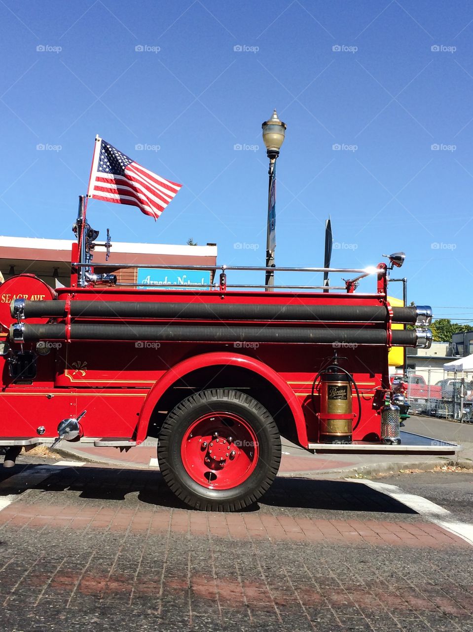 Fire trucks flies freedom. Classic fire truck displays American patriotism with American flag
