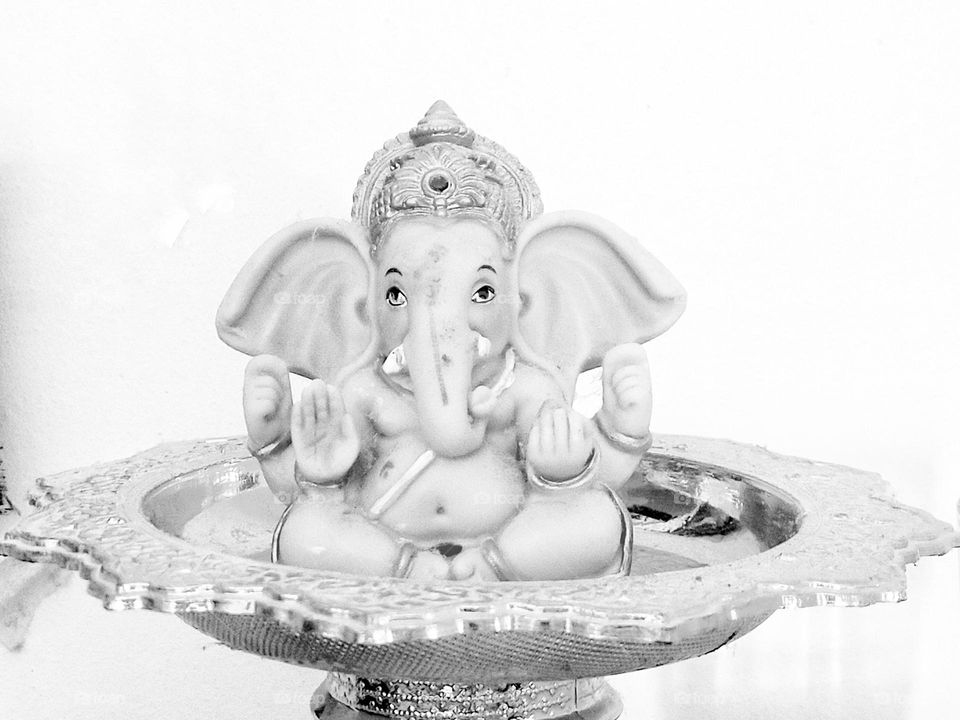 The photograph of the Lord Ganesha is placed on the pedestal.
