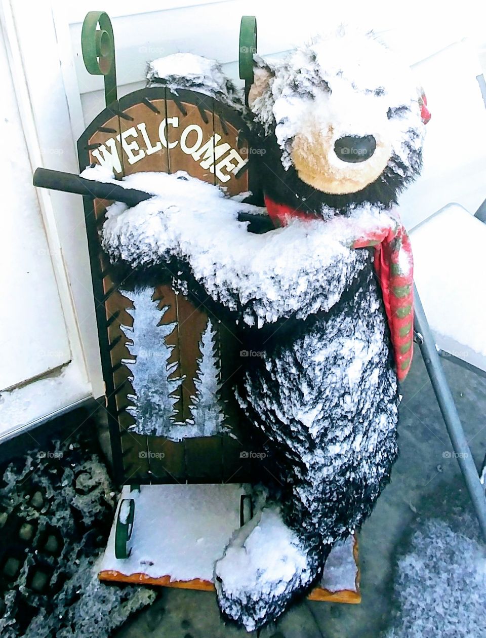 Our door bear got snowed!