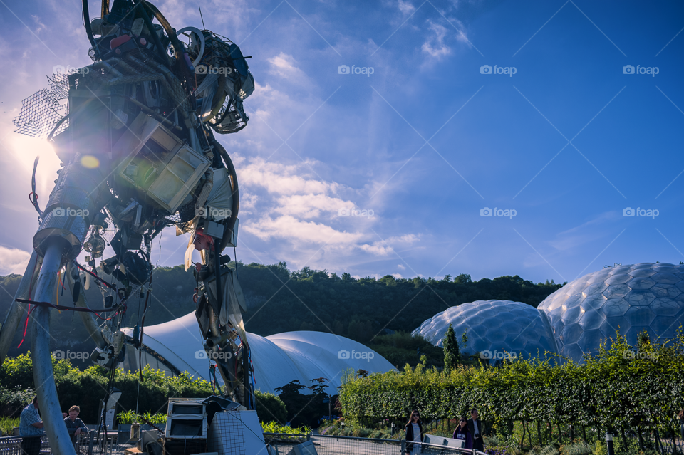 WEEE Man watches over The Eden Project.  WEEE Man is a sculpture made from discarded household electrical items to highlight the need for better recycling.  The Eden Project, Cornwall, England, location for filming James Bond "Die Another Day".