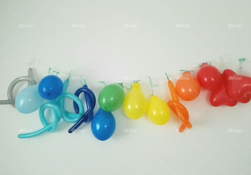 colorful balloons hanging on white wall