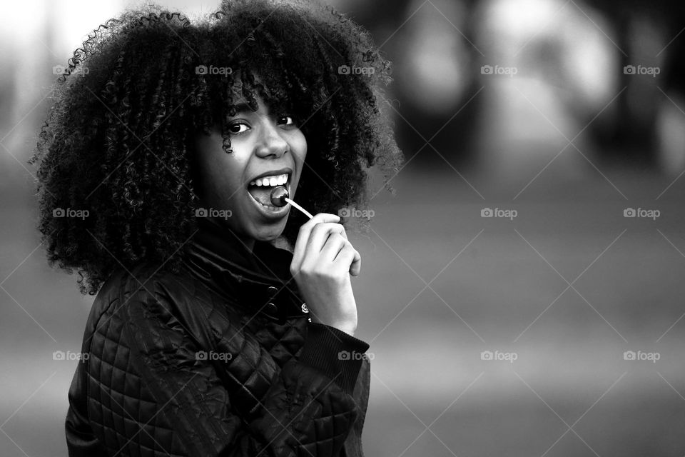 Black and White portrait of latin girl with lollipop