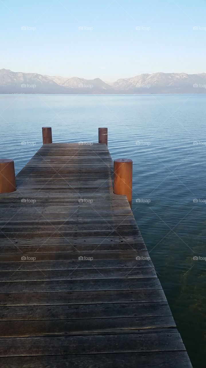 Wooden dock looking toward the mountains of beautiful Lake Tahoe