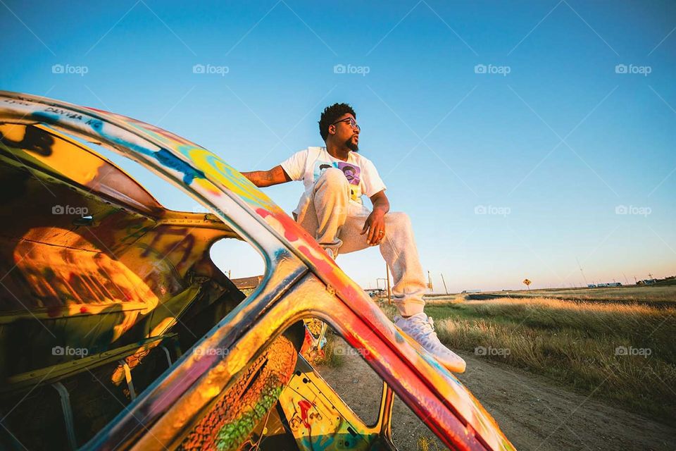 Travel by car is something that must include randomly dipping off. Photo of my husband at the Slug Bug Ranch in Texas.