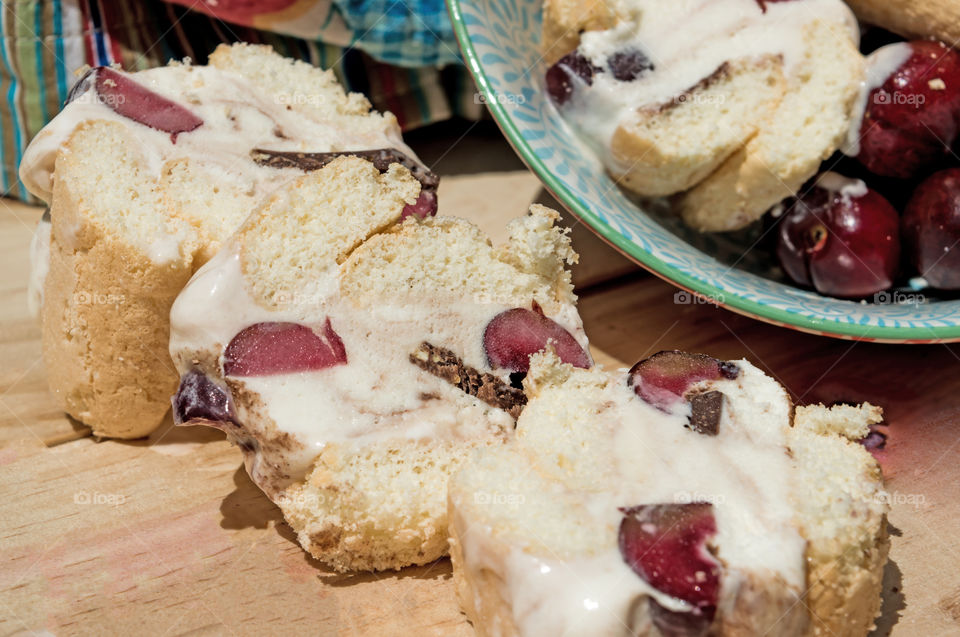 Home made ice cream sandwiches with vanilla ice cream, cherry and dark chocolate filling outdoors with bowl and lady fingers summer entertaining gourmet homemade dessert photography 