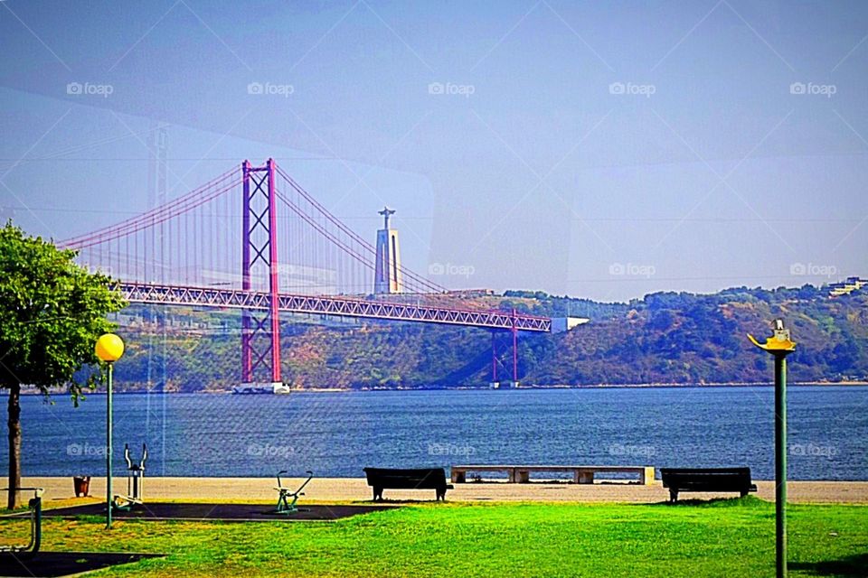 Empty benches overlooking the 25 de abril bridge 