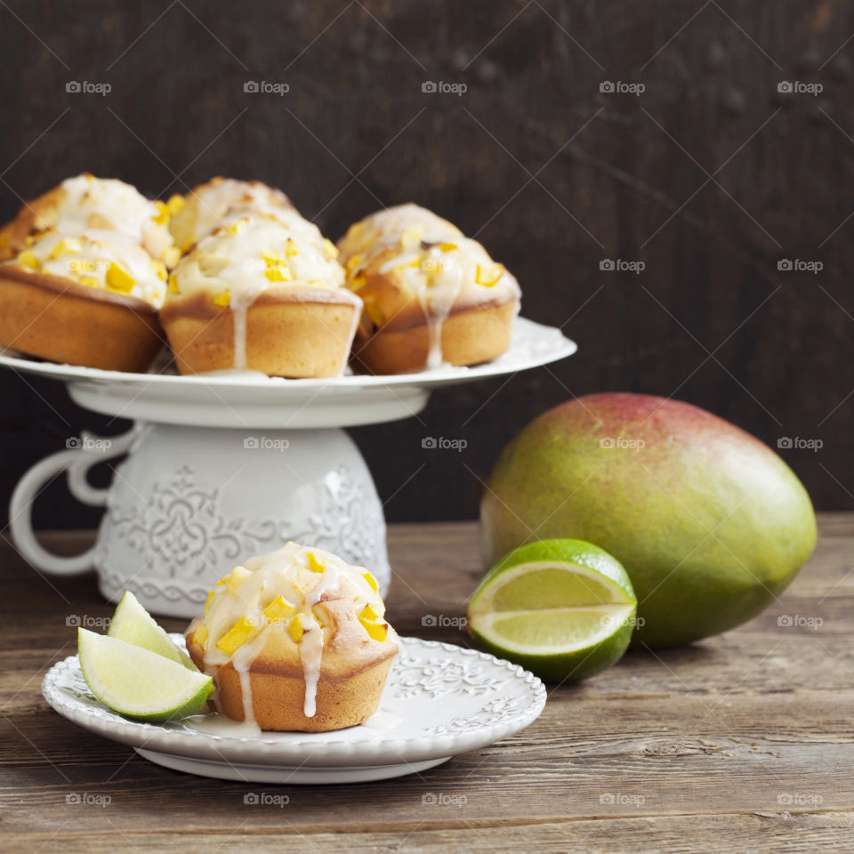 Muffins with fruits on the wooden table