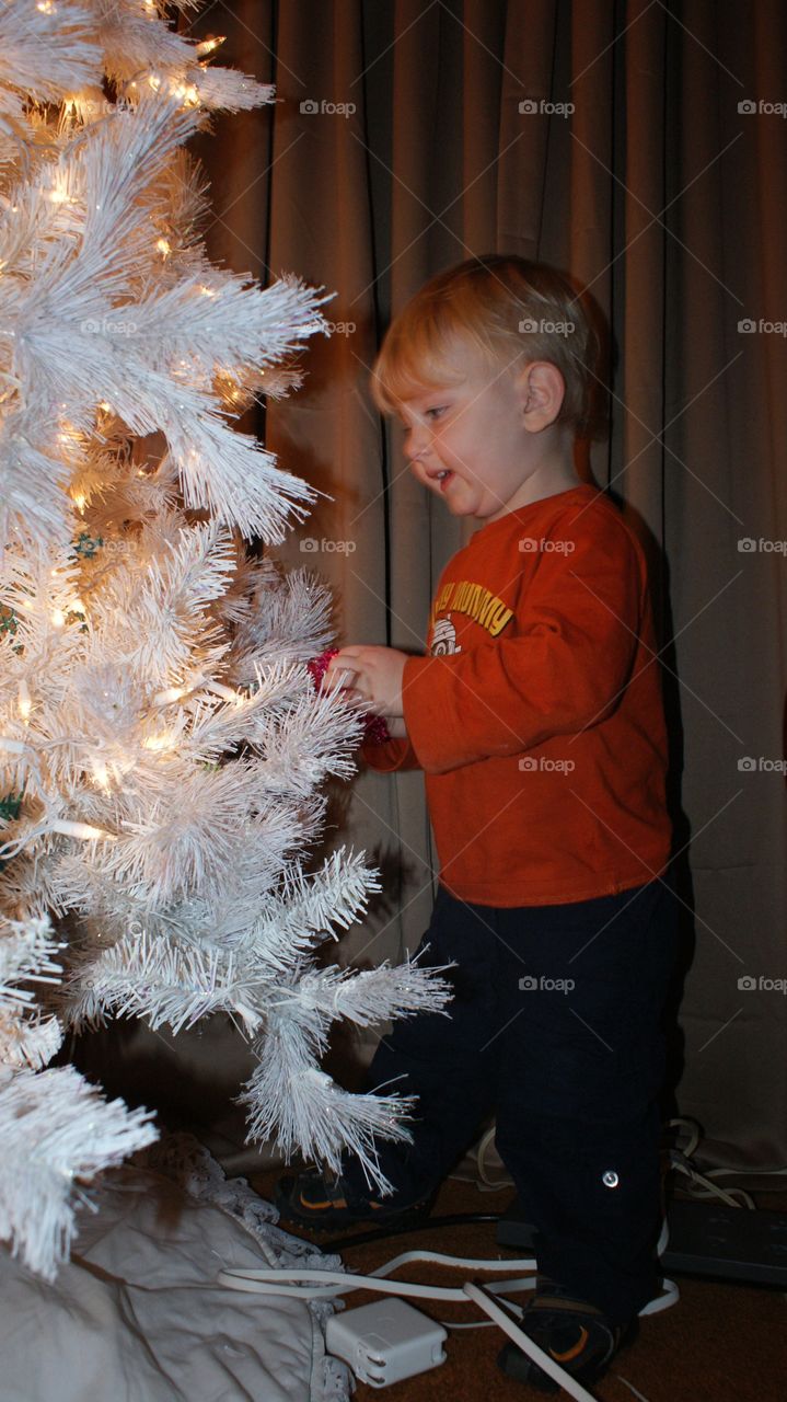 Decorating the tree with mason hanging ornaments 