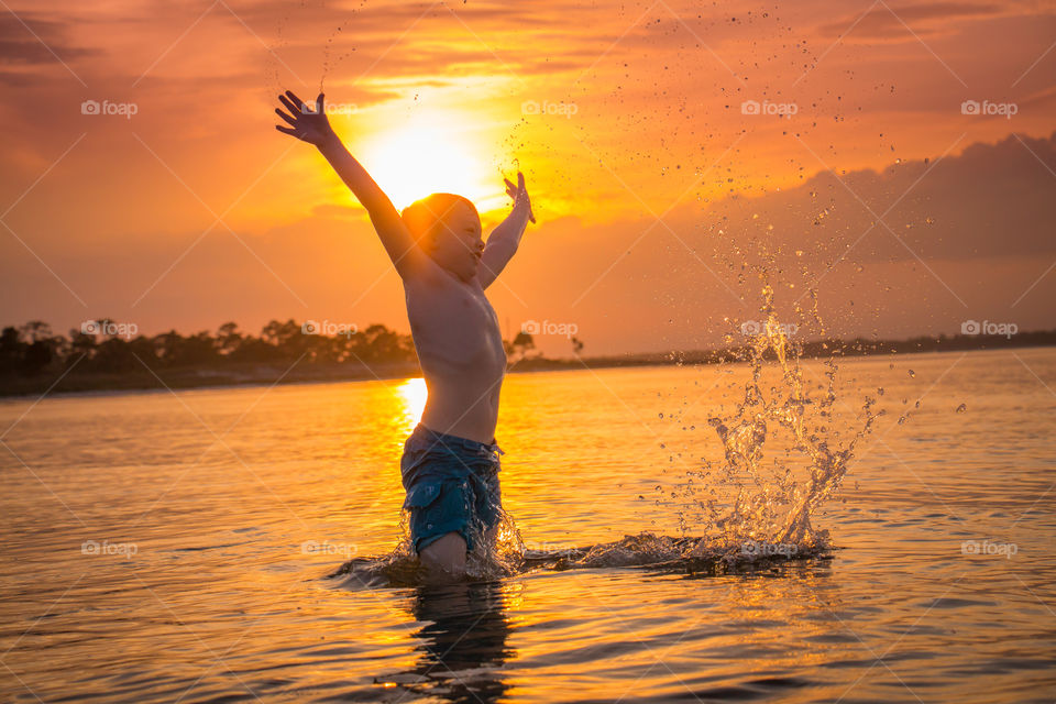 Jumping. My son jumping up from the ocean
