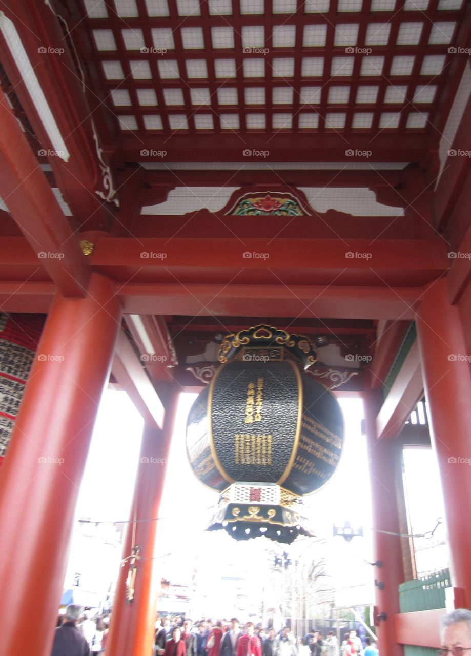 Asakusa, Tokyo, Japan.  Traditional tori gate with giant lantern outside Kaminarimon gate, before Sensoji temple.