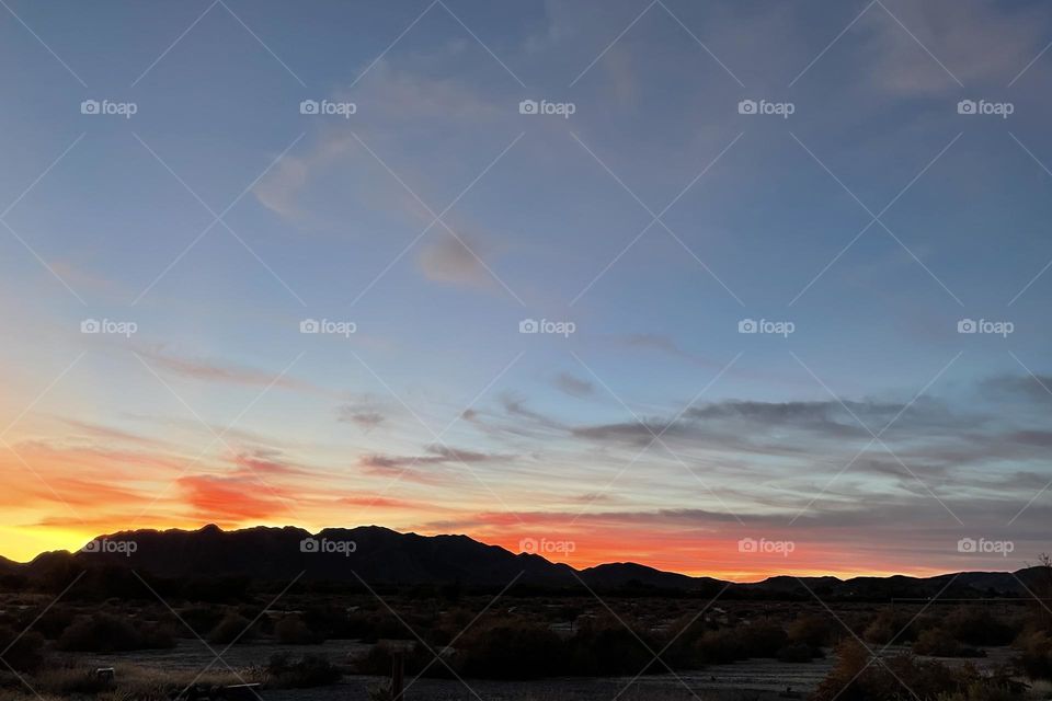 A mountain sunset with pink clouds.