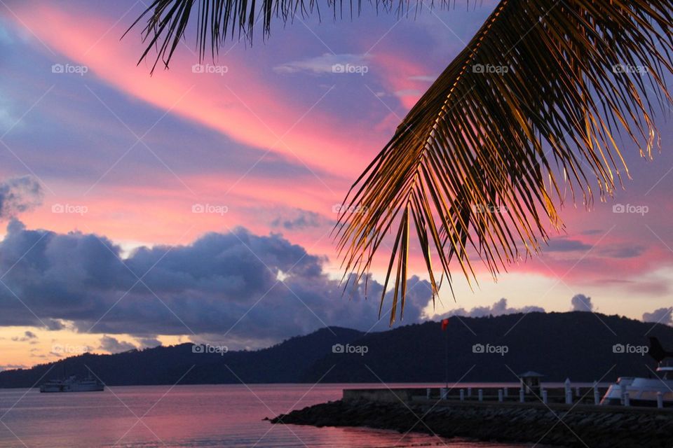 Scenic view of sea and mountains at sunset