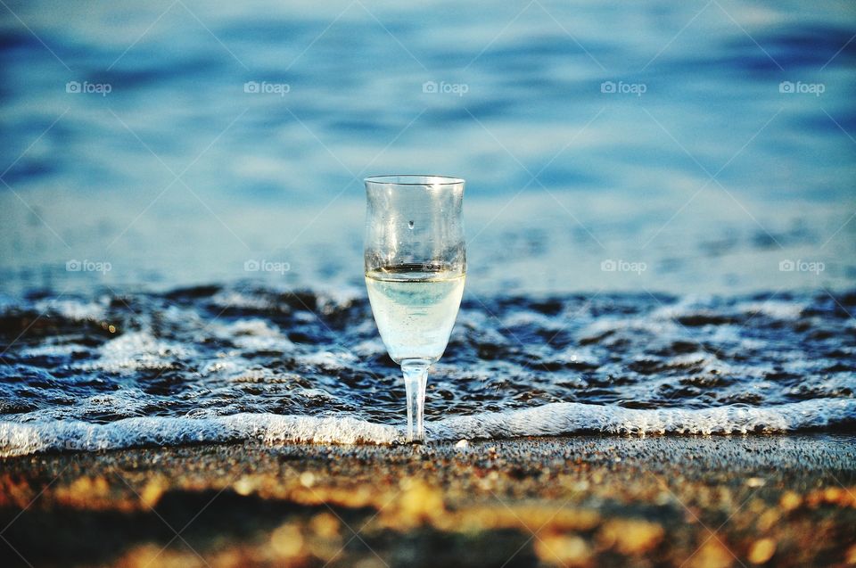 champagne glass on the beach at the baltic sea coast in poland