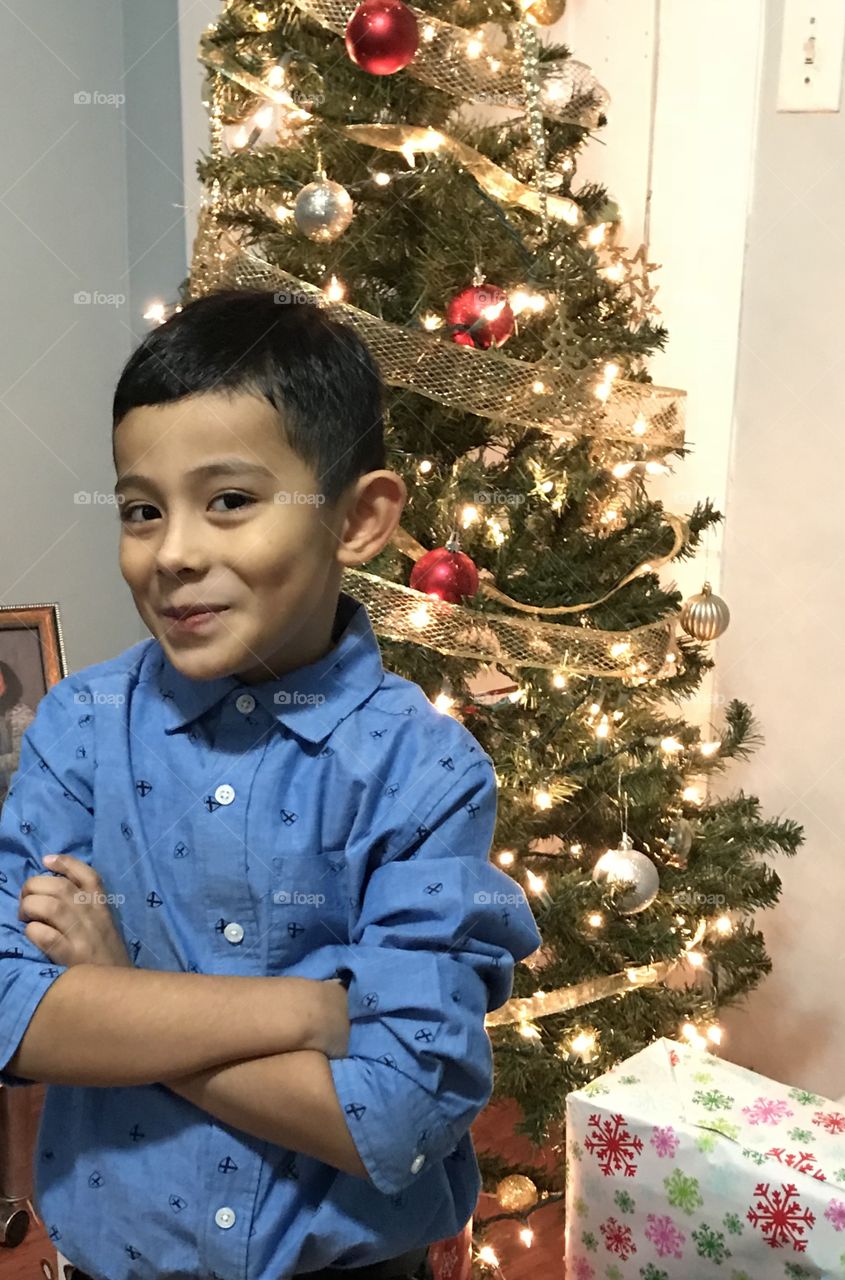 Nephew in front of Christmas tree anxious waiting