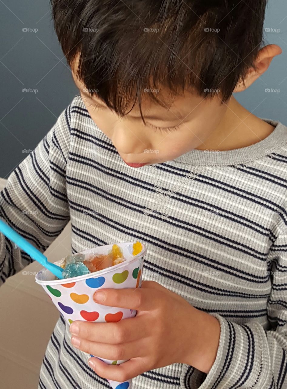 Little boy eating shaved ice