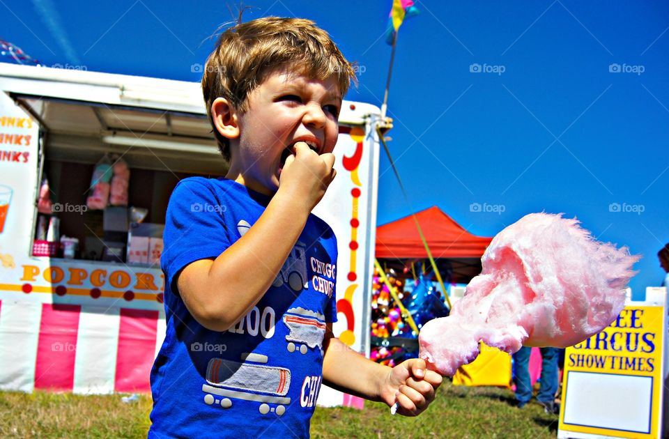 Close-up of a boy eating sugar candy