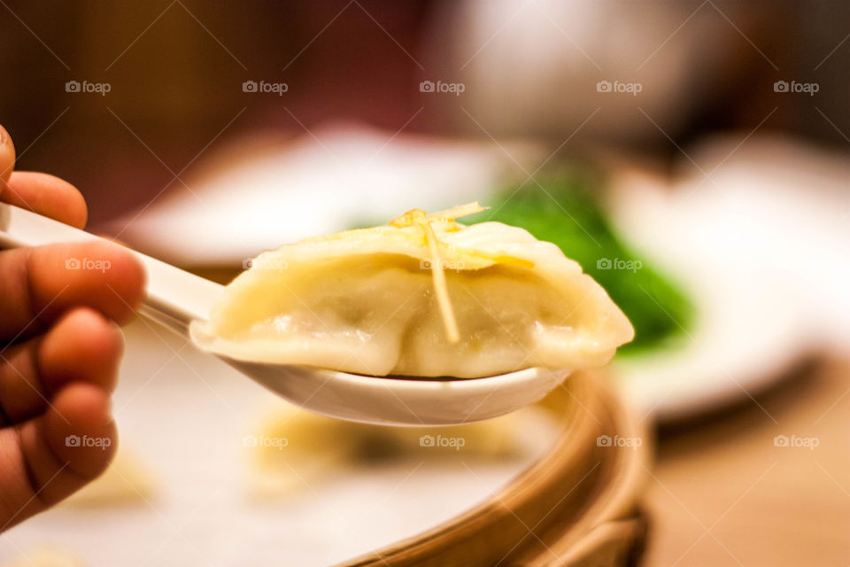 Dumpling food on spoon in restaurant