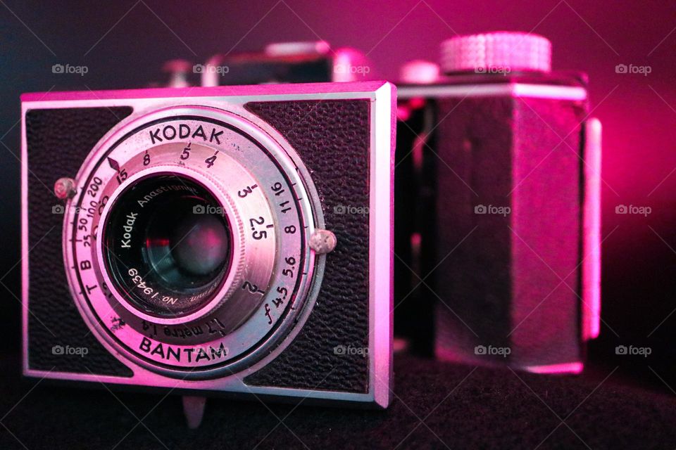Close up of a Kodak bantam camera, from days gone by, vintage glowing in red lighting 