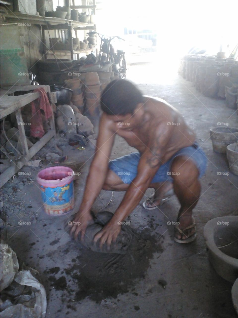 kneading clay to make the pots