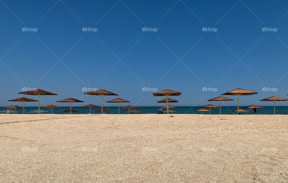 Minimalistic beach with triangle parasols