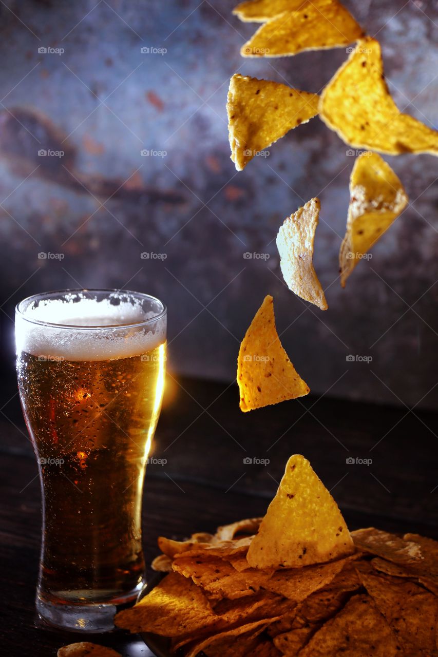 Glass of cold beer and chips