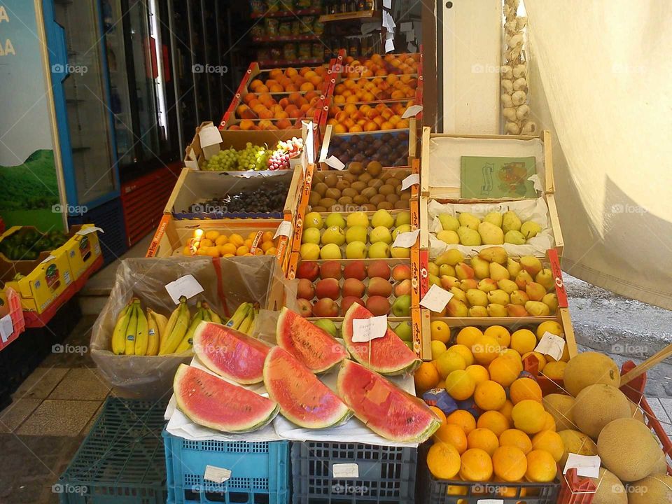 fruit rainbow in beautiful Parga, Greece.
all sorts of food in a traditional market store in Greece.
oranges, pears, appricots, melons, watermelons, bananas, peaches, grapes, coconuts.