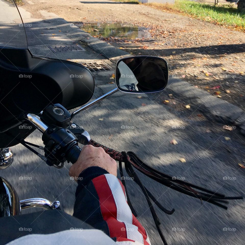 View of our Harley ride from the back seat 🏍! Fringe flying in the wind & my hubby's strong arm taking control as we go down the road with our leathers on!👍🏍