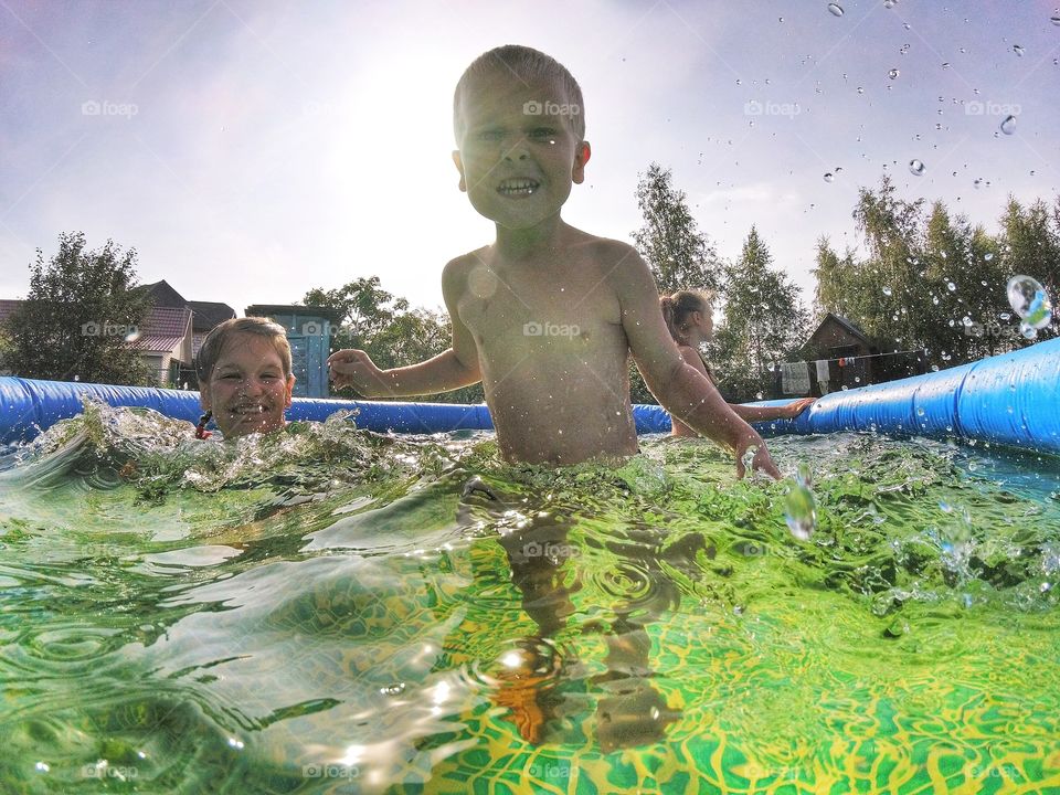 Kids swimming in the swimming pool