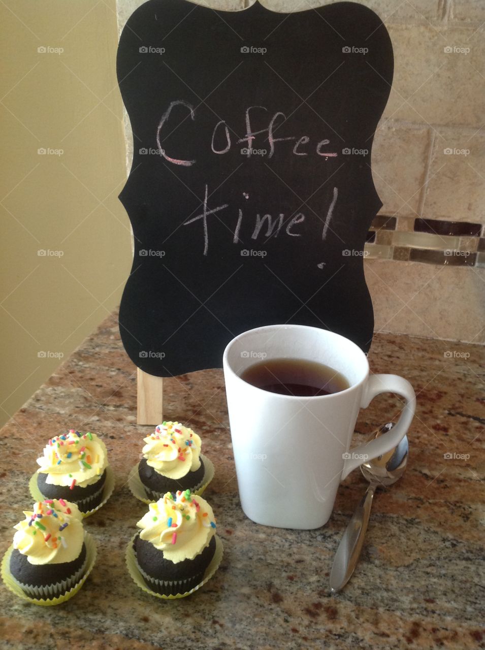 It's coffee time! Enjoying a cup of coffee with mini cupcakes.