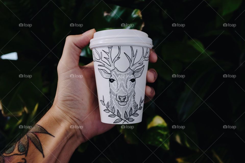 Deer illustration on a white coffee cup. 