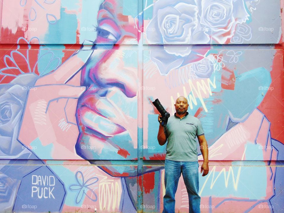 Photographer  Posing for the camera With zoom lens camera in hand