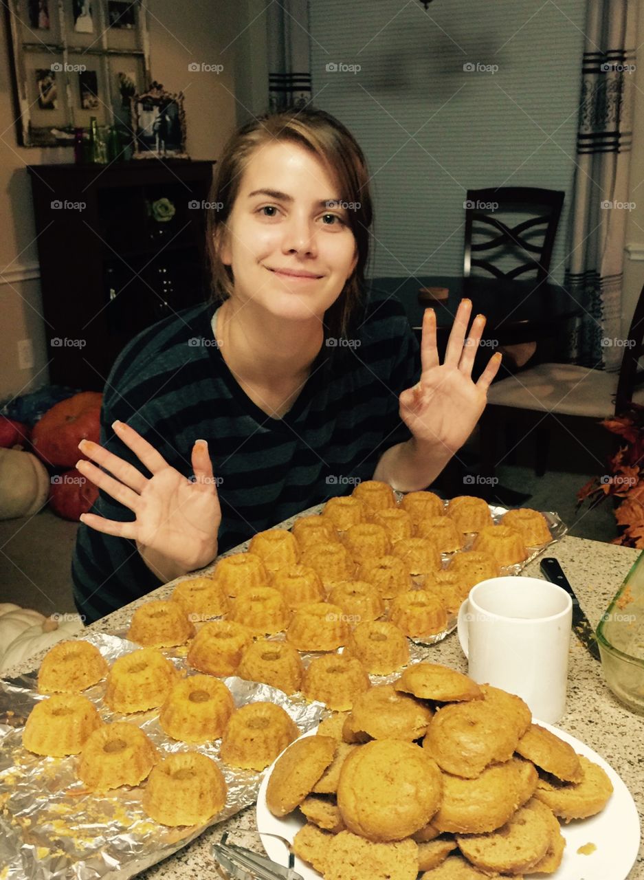 Smiling woman with arranged baked food