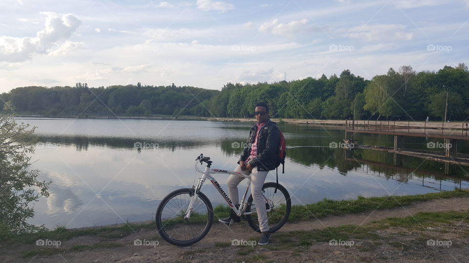 Man sitting on sport bike near the lake