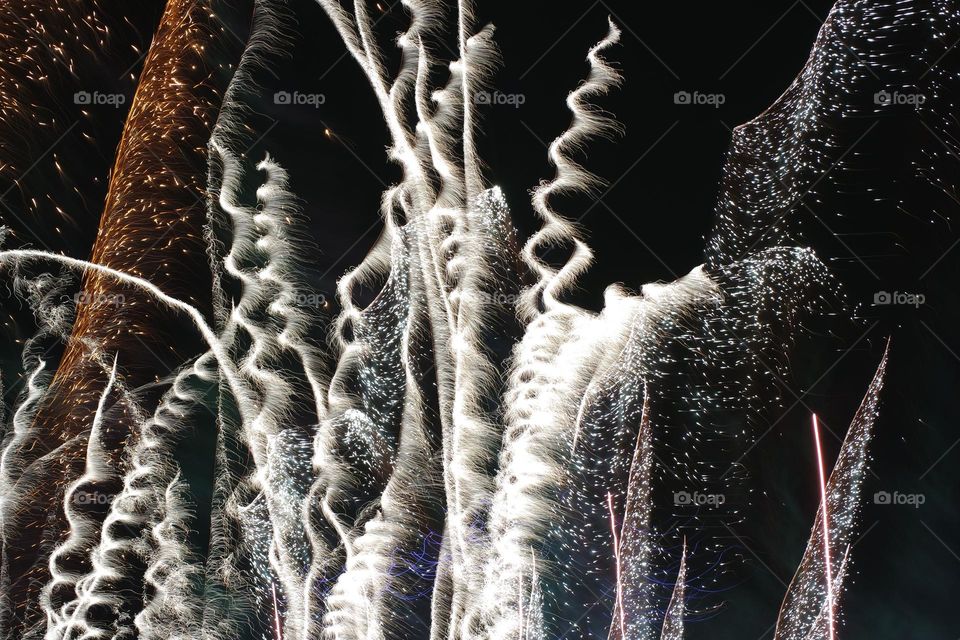 Squiggly fireworks scream up and into the night sky at the beginning of the amazing firework show at the Perth Royal show