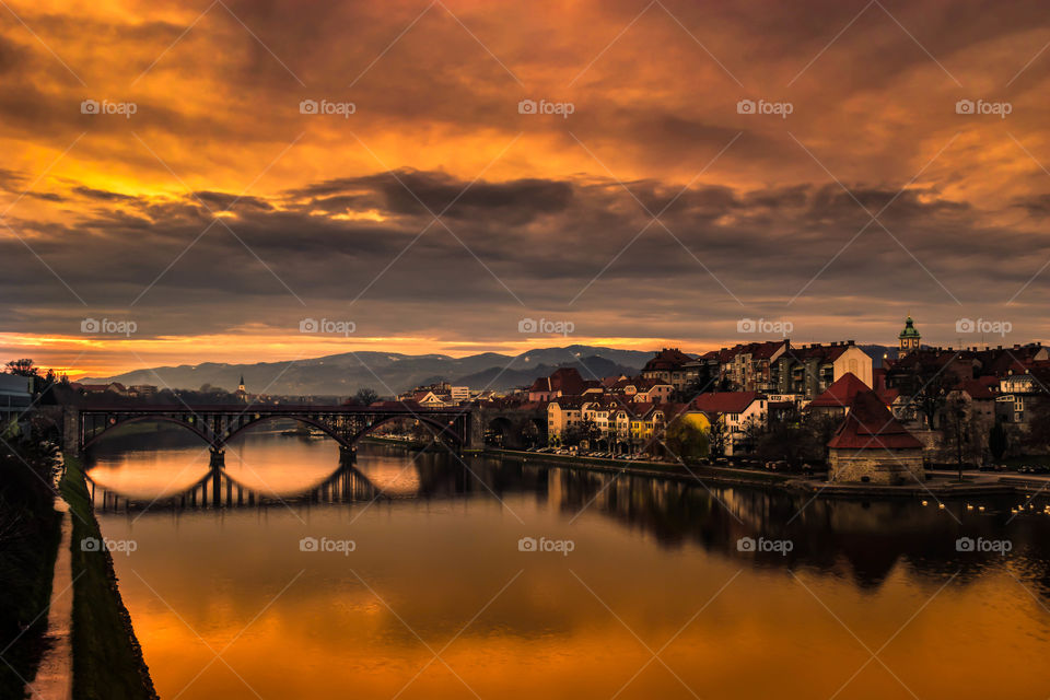 View of arch bridge over river in the city