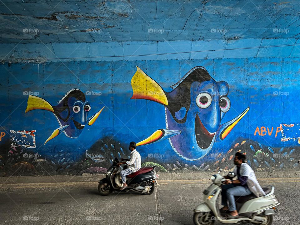 People commuting in their scooters in a city