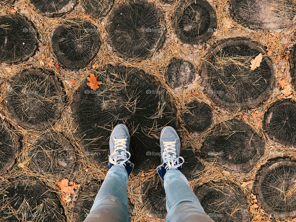 Standing on wooden circles with pine needles 