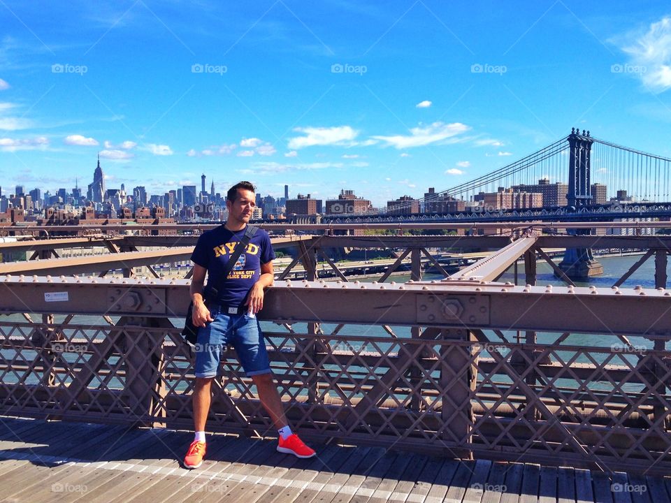 N.Y.P.D man on the Brooklyn bridge. N.Y.P.D man on the Brooklyn bridge in a sunny afternoon