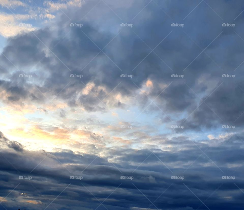 the sun disappearing behind the clouds.