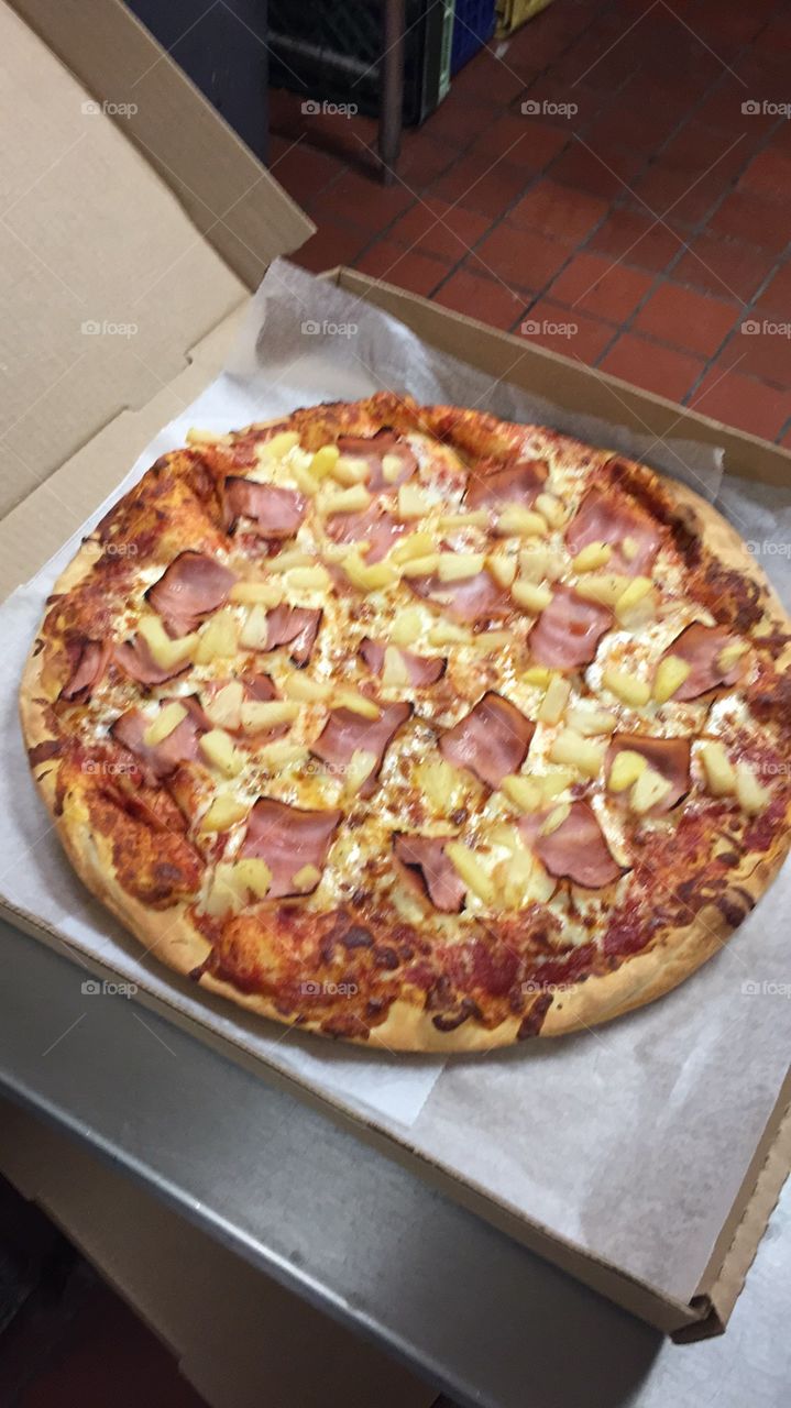 Ham and pineapple pizza on fresh dough.   