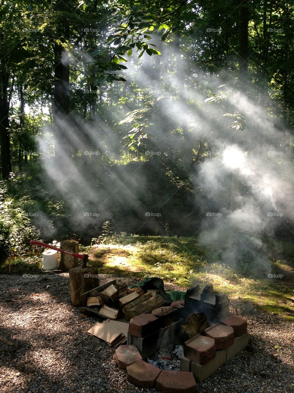 Sun rays shining through smoke from campfire
