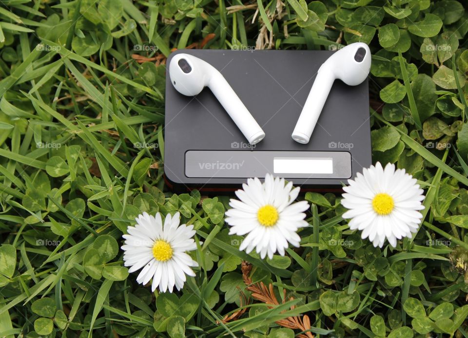 hotspot Wi-Fi earbuds in an open field outdoors