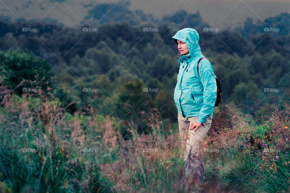 Taking rest on mountain trail. Woman taking a rest on mountain trail