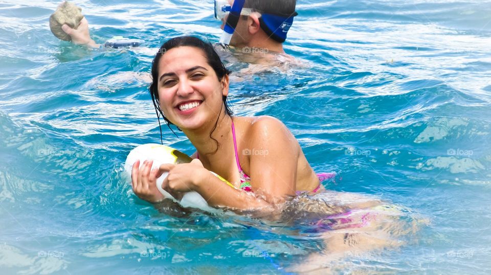 Beautiful college girl having fun in the pool