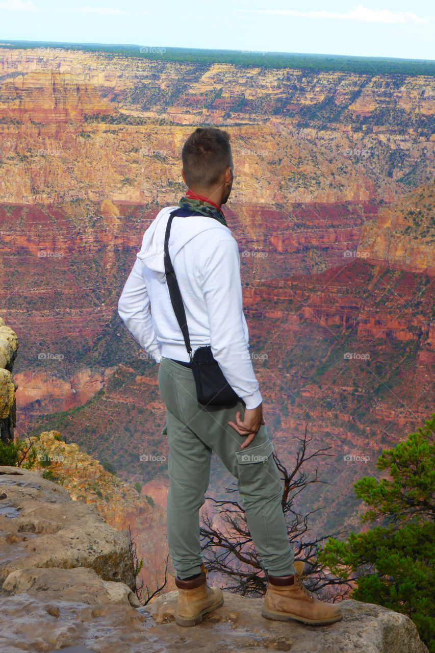 Man is looking the magnificent colors of the canyon at sunset,Grand canyon,Arizona
