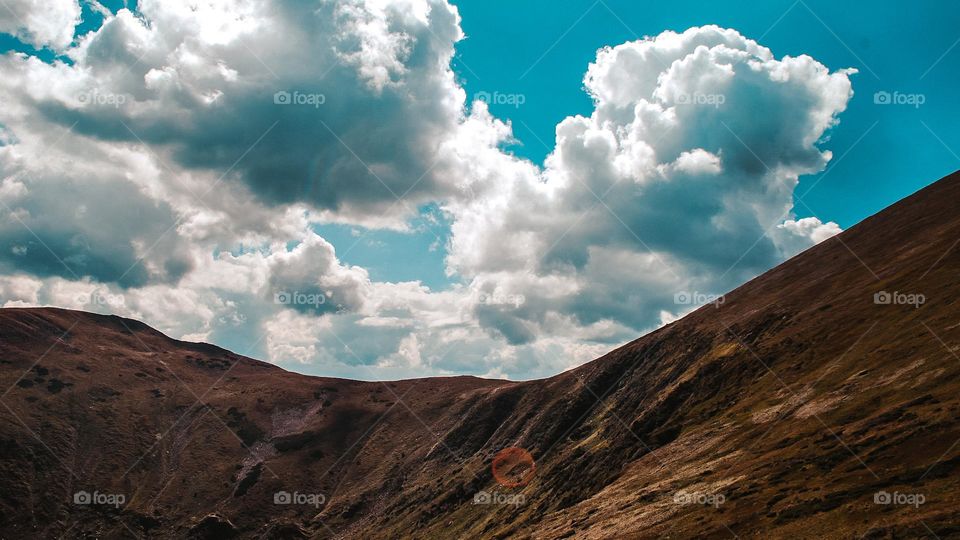 Massive clouds hung over the mountain range.