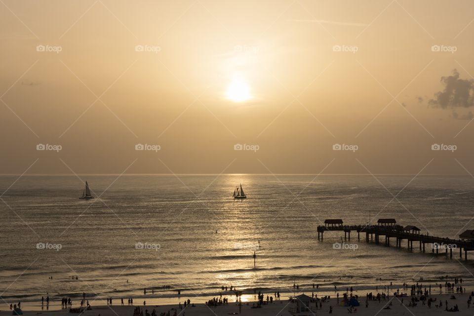 Sailboat and pier at beautiful sunset 