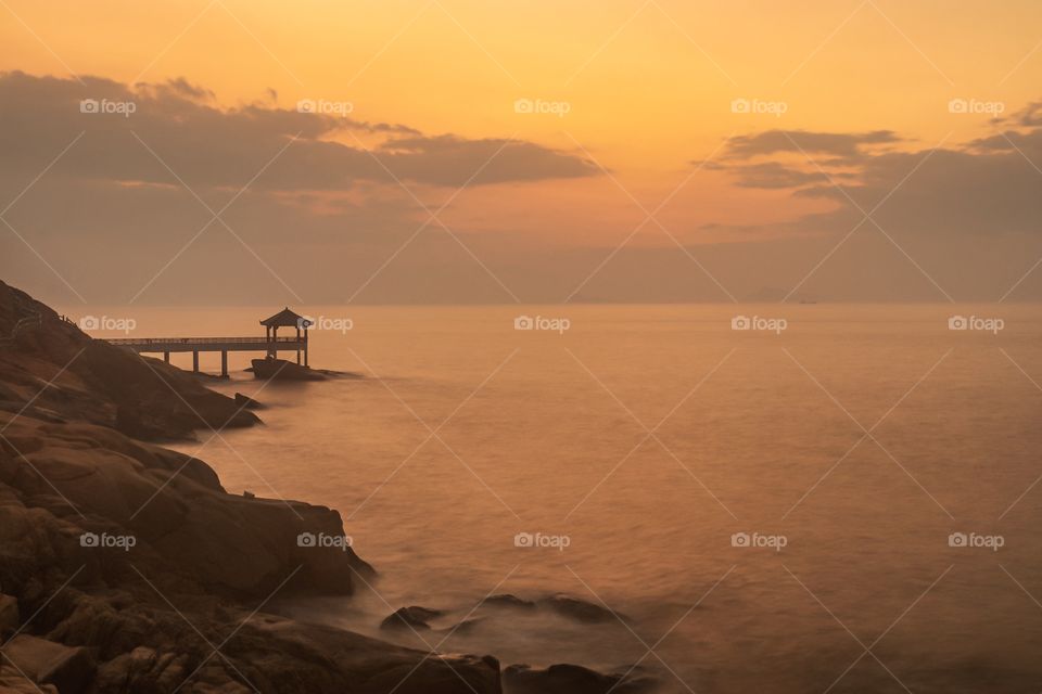Break of dawn at the coastline of Long Chao Kok Trail... seen on the background the Gazebo rest stop and the South china sea